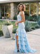 Woman in a light blue evening gown with ruffled layers standing outdoors.