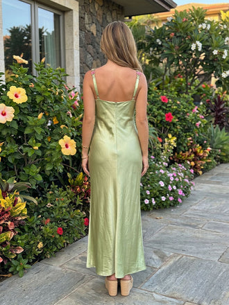 Back view of sage green formal satin dress with square back and slim embroidered straps

