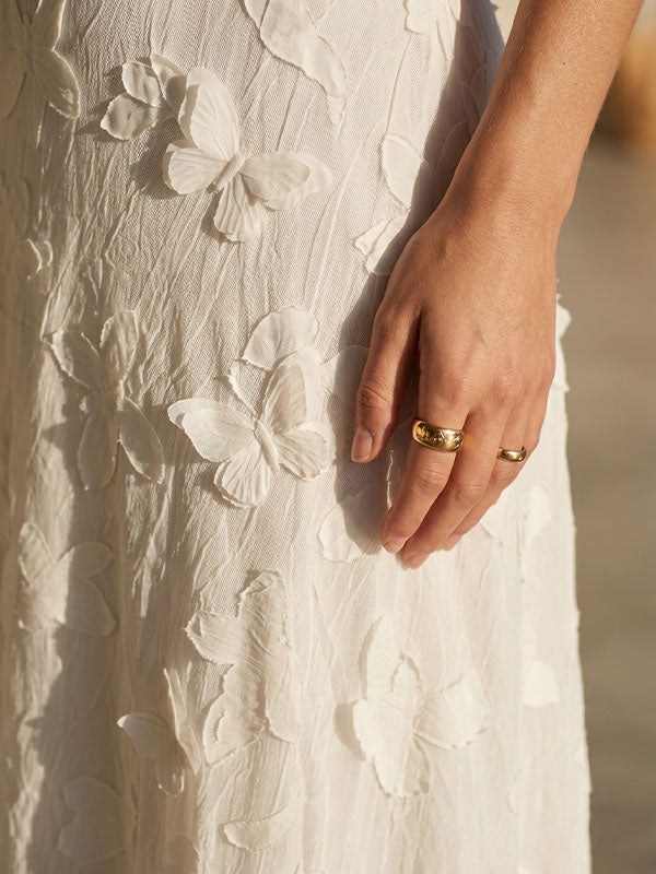 textured woven fabric white maxi dress soft luxury material close up