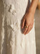textured woven fabric white maxi dress soft luxury material close up