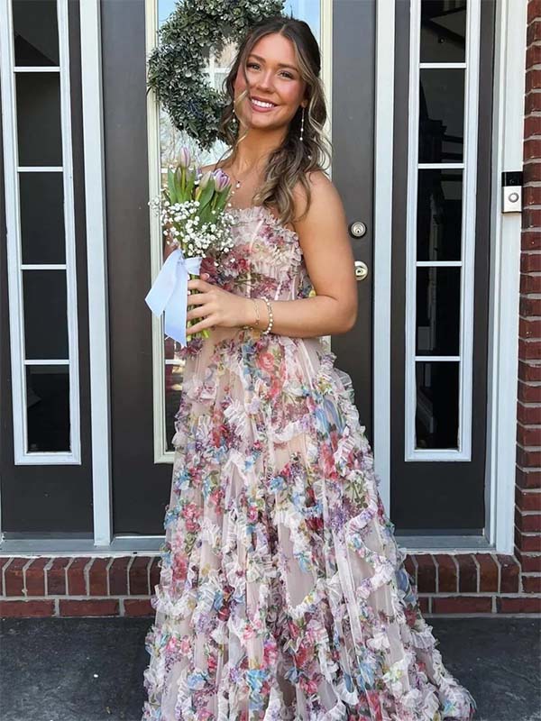 Woman in a floral dress holding flowers in front of a door