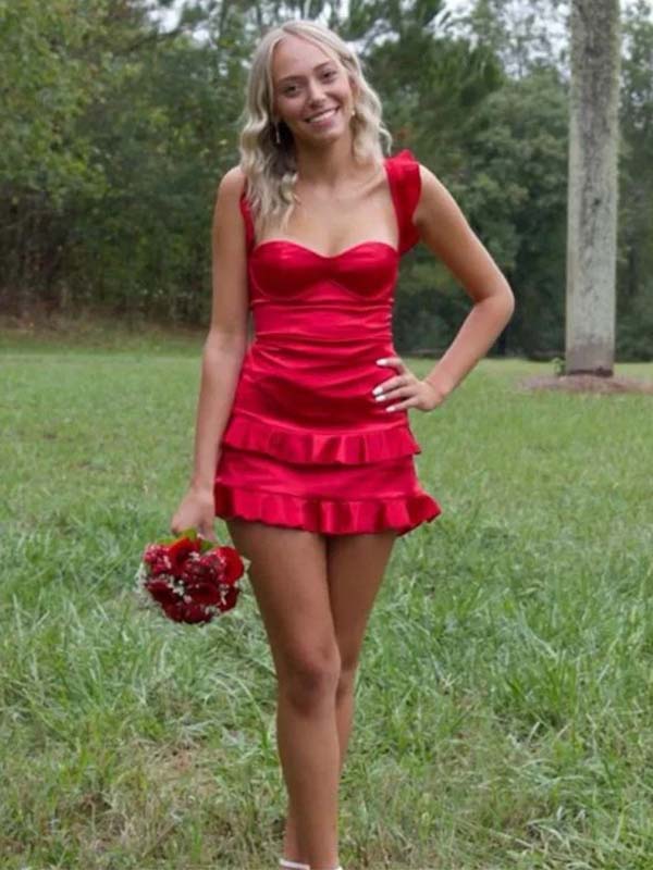 Woman in a red dress standing in a grassy area
